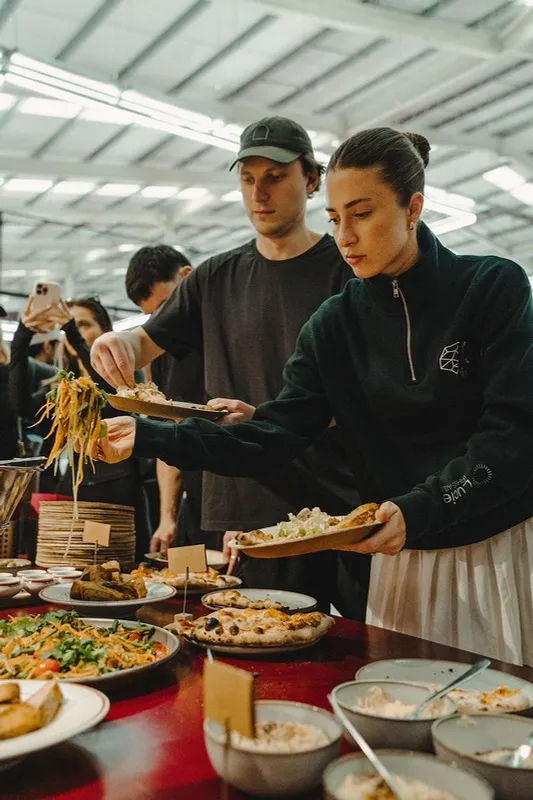 Guests helping themselves from a courtside buffet.