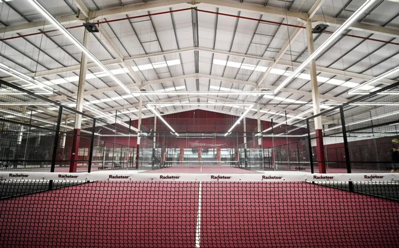 The Main Hall's red courts under the 12.8m roof.